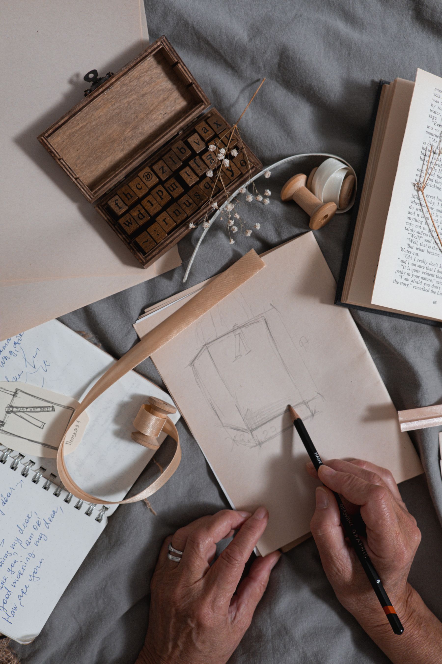 Real creative workspace with notebook and materials